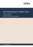 Eine kleine Burg im weissen Sand